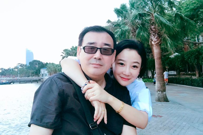 Yang Hengjun pictued with his wife. She has his arms around his shoulders and they're smiling