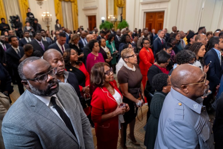 Members of the audience listen as President Joe Biden speaks at a reception in recognition of Black History Month in the East Room of the White House in Washington
