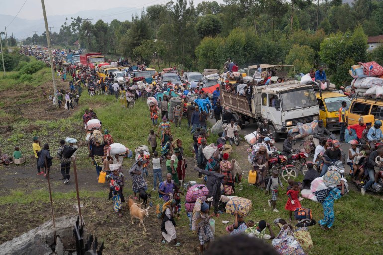 Thousands who are fleeing the ongoing conflict between government forces and M-23 rebels reach the entrance the Democratic Republic of Congo eastern city of Goma Wednesday, Feb. 7
