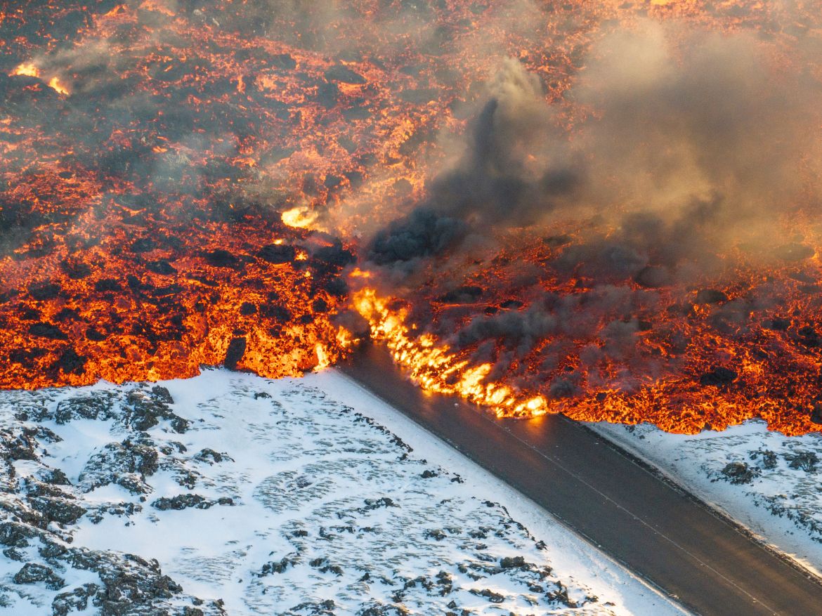 Lava crosses the main road to Grindavík and flows on the road leading to the Blue Lagoon, in Grindavík, Iceland