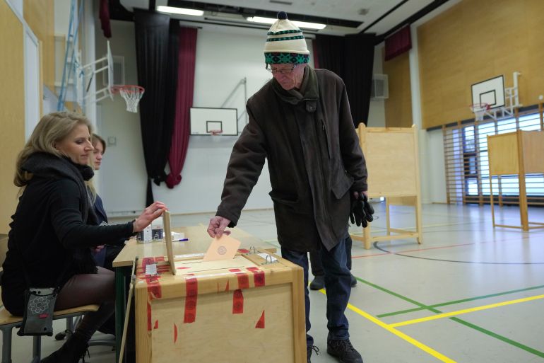 A man casts his ballot at a polling station during a presidential election in Espoo, Finland, Sunday, Feb. 11, 2024. Voters in Finland are choosing Sunday between two experienced politicians to be their next president. (AP Photo/Sergei Grits)