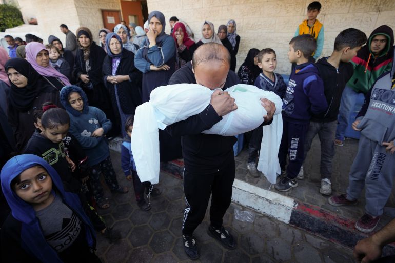 A Palestinian morns a relative killed in the Israeli bombing of the Gaza Strip in Deir al Balah