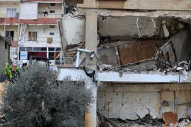Civil defence and rescue workers remove rubbles from a building that was attacked Wednesday night by an Israeli airstrike, in Nabatiyeh town