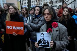 A woman holds a portrait of Russian opposition leader Alexey Navalny, who died in a Russian prison on February 16, during a protest in Berlin [AP/Ebrahim Noroozi]
