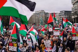 Protesters hold up flags and placards during a demonstration in support of Palestinian people in Gaza, in London, Saturday, Feb. 17, 2024 [AP Photo/Alberto Pezzali]