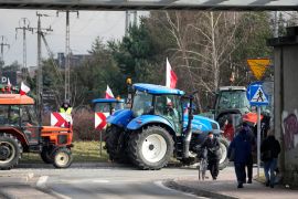 Polish farmers drive tractors in a convoy as they protest against the import of Ukrainian foods and European Union environmental policies, in Minsk Mazowiecki, Poland [Czarek Sokolowski/AP Photo]