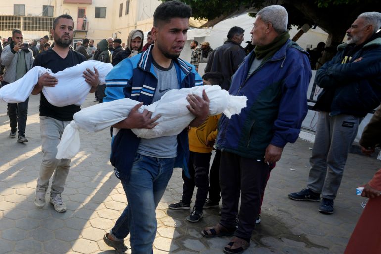Palestinians carry the bodies of children killed in the Israeli bombardment of the Gaza Strip at Al Aqsa Hospital in Deir al Balah on Tuesday, Feb. 20, 2024. (AP Photo/Adel Hana)