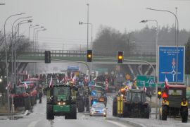 Polish farmers drive tractors in a convoy in Minsk Mazowiecki, Poland, as they intensify a nationwide protest [Czarek Sokolowski/AP Photo]