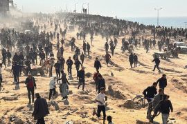 Palestinians wait for humanitarian aid on a beachfront in Gaza City, Gaza Strip [Mahmoud Essa/AP Photo]
