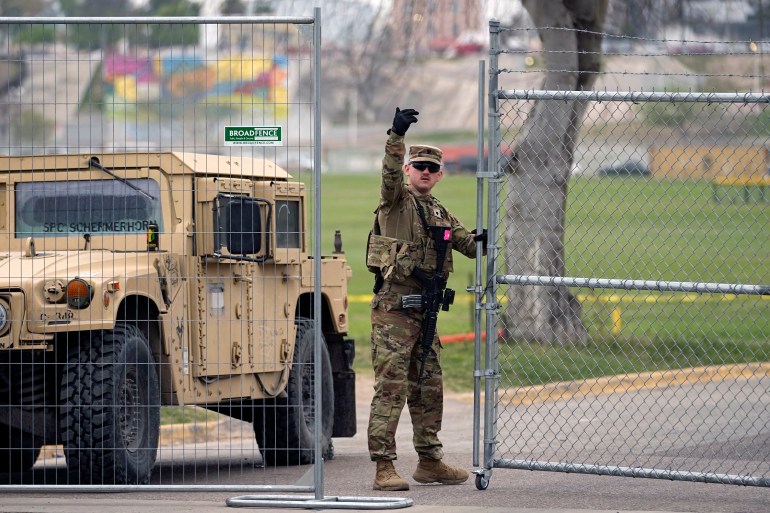 A member of the National Guard directs a vehicle at the gate to Shelby Park along the Rio Grande