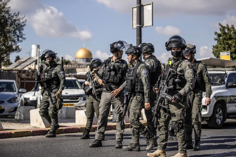 Israeli forces take security measures as Muslims perform Friday prayers on street in Old City