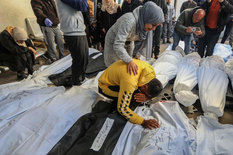 People mourn as they receive the bodies of victims of an Israeli attack on February 8, 2024 in Rafah, Gaza