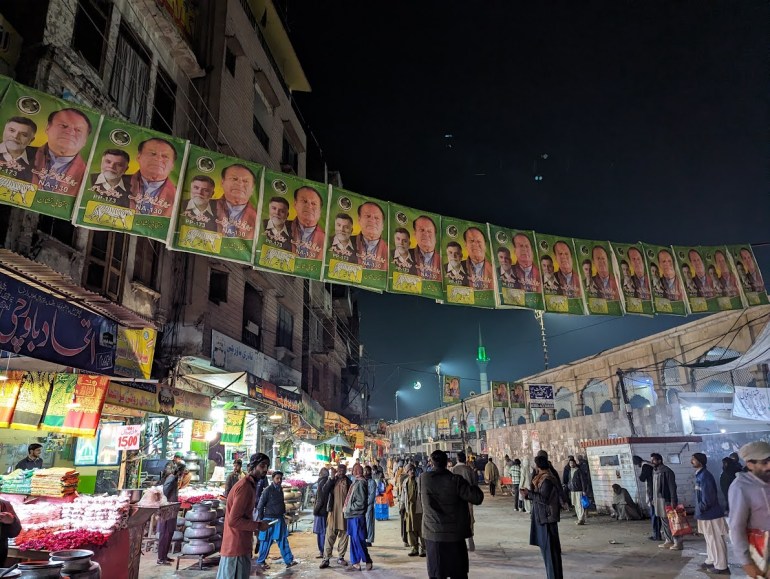 Banners for three-time prime minister Nawaz Sharif hanging outside the Data Darbar shrine in Lahore. [Abid Hussain / Al Jazeera]