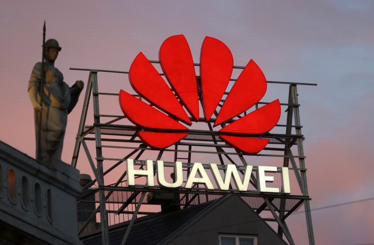 The logo of the Chinese telecommunications giant Huawei Technologies is pictured next to a statue on top of a building in Copenhagen, Denmark, June 23, 2021. REUTERS/Wolfgang Rattay