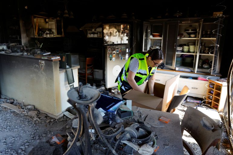 A representative from the Israeli Ministry of Defence works inside a damaged house following the October 7 deadly attack by Palestinian Islamist group Hamas, in Kibbutz Beeri, in southern Israel, November 16, 2023
