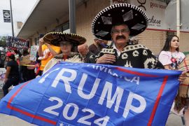 A supporter in a sombrero waves a Trump 2024 flag in Texas.