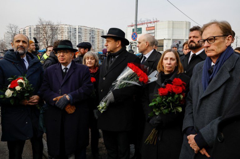 Foreign diplomats, including French Ambassador to Russia Pierre Levy and U.S. Ambassador to Russia Lynne Tracy, wait near the Soothe My Sorrows church before a funeral service and a farewell ceremony for Russian opposition politician Alexei Navalny in Moscow, Russia