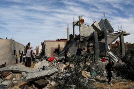 Palestinians gather at the site of an Israeli strike on a house in Rafah in the southern Gaza Strip, March 1, 2024 [Ibraheem Abu Mustafa/ Reuters]