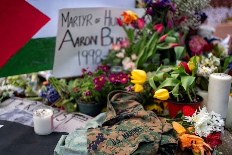 A United States Marines jacket, flowers and candles are placed outside the Israeli Embassy in Washington at a memorial for Aaron Bushnell