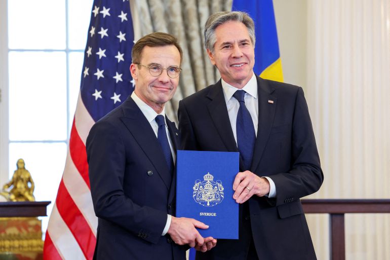 U.S. Secretary of State Antony Blinken accepts Sweden's instruments of accession from Swedish Prime Minister Ulf Kristersson for its entry into NATO at the State Department in Washington