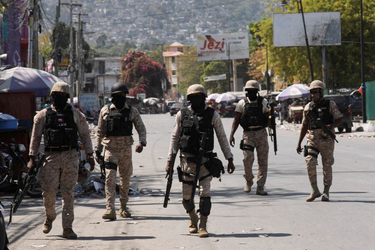 Haitian police officers patrol a street of Port-au-Prince