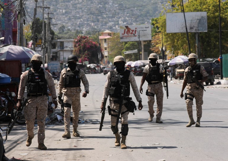 Haitian police officers patrol a street of Port-au-Prince