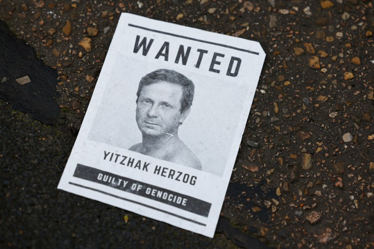 A flyer with a picture of Israeli President Isaac Herzog lies on the site of a protest in front of the National Holocaust Museum 