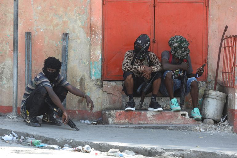 Gang members sit together in Port-au-Prince, Haiti