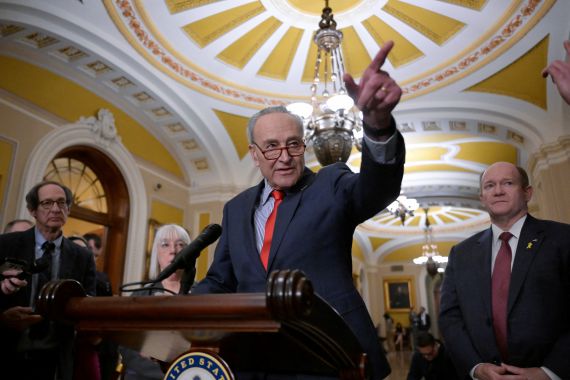 Chuck Schumer points during a press conference.
