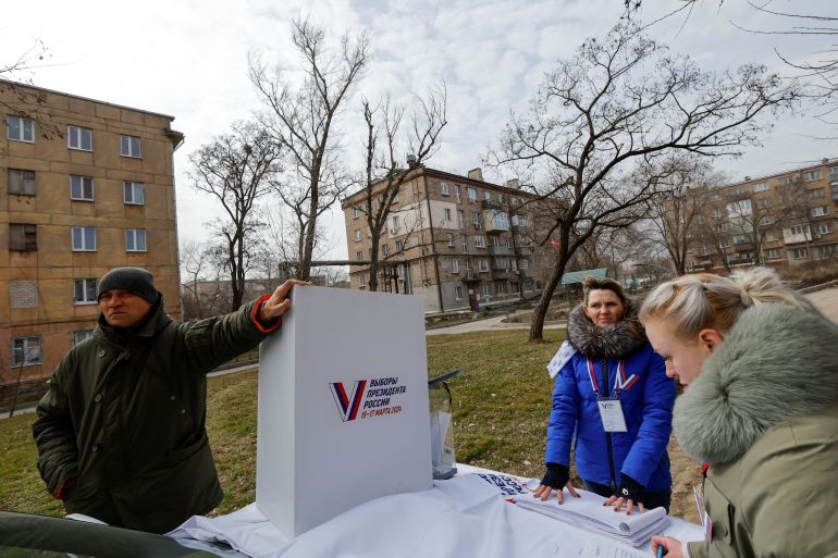 Members of a local electoral commission work at a mobile polling station during the early voting in Russia’s presidential election, in the course of Russia-Ukraine conflict in Mariupol, Russian-controlled Ukraine, March 13, 2024. REUTERS/Alexander Ermochenko