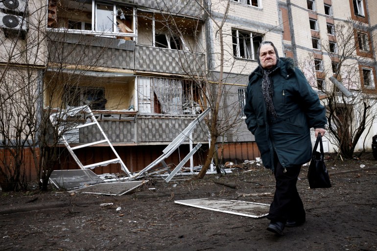 A woman walks past a building, damaged during a Russian missile strike, amid Russia's attack on Ukraine, in Kyiv, Ukraine March 21, 2024. REUTERS/Thomas Peter