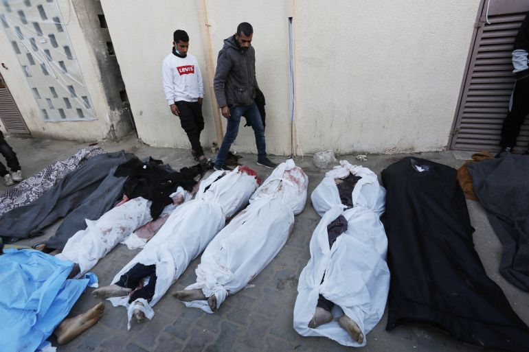 Bodies of Palestinians, died during the Israeli attacks on a house belonging to Batran family in the Nuseirat Refugee Camp, are taken from the morgue of Al-Aqsa Martyrs Hospital