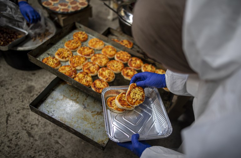 RAFAH, GAZA - MARCH 10: A group of volunteer Palestinian women in Gaza are seen preparing food to distribute to families who fled Israeli attacks and took refuge in Rafah city as part of preparations for the upcoming holy month of Ramadan, in Rafah