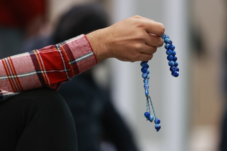 A man holds prayer beads as Muslims perform tarawih prayer on the first night of Ramadan at Anatolia Islamic Centre in Mississauga area of Toronto