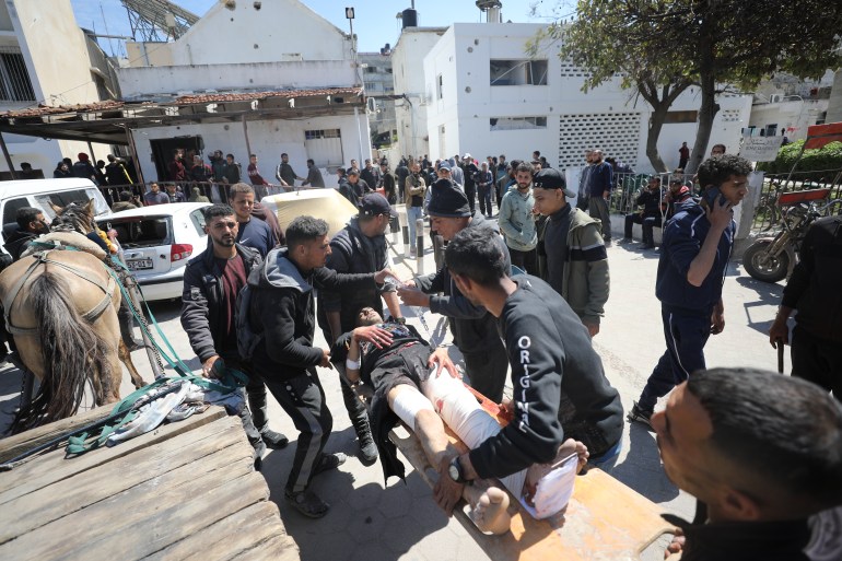 Wounded Palestinians, including children, are taken by horse-drawn carriage to al-Ahli Baptist Hospital after Israel hit Palestinians waiting for humanitarian aid at Kuwait Junction in Gaza City