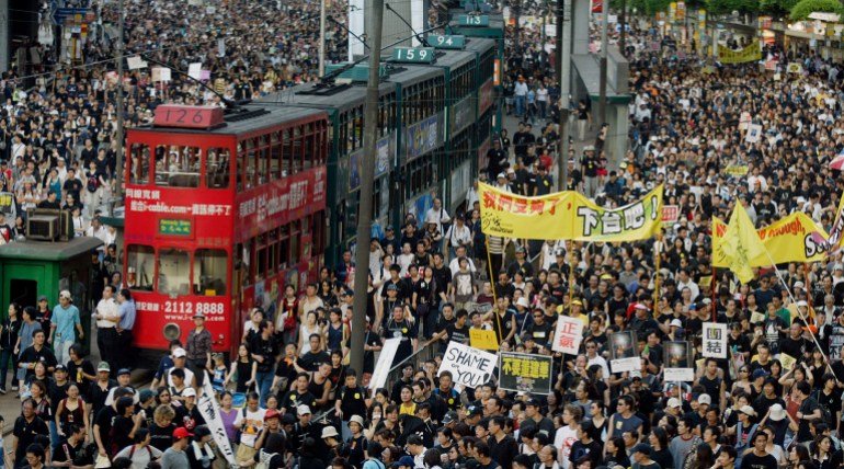 Mass protests against Article 23 in Hong Kong in 2003. Trams have been brought to a standstill