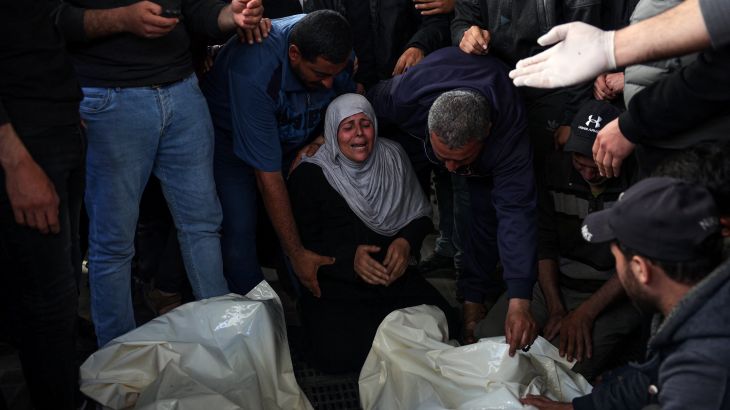 Palestinian mourners cry over the bodies of loved ones at Al-Najjar Hospital in Rafah