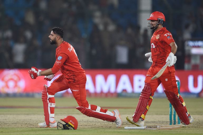 Islamabad United's Imad Wasim (L) Haider Ali (R) celebrate their victory at the end of the Pakistan Super League (PSL) Twenty20 cricket eliminator match between Islamabad United and Peshawar Zalmi at the National Stadium in Karachi on March 16, 2024. (Photo by Rizwan TABASSUM / AFP)