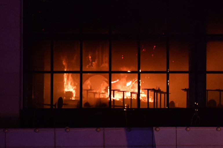A view shows the burning Crocus City Hall concert hall following the shooting incident in Krasnogorsk, outside Moscow, on March 22, 2024. - Gunmen opened fire at a concert hall in a Moscow suburb on March 22, 2024 leaving dead and wounded before a major fire spread through the building, Moscow's mayor and Russian news agencies reported. (Photo by Olga MALTSEVA / AFP)