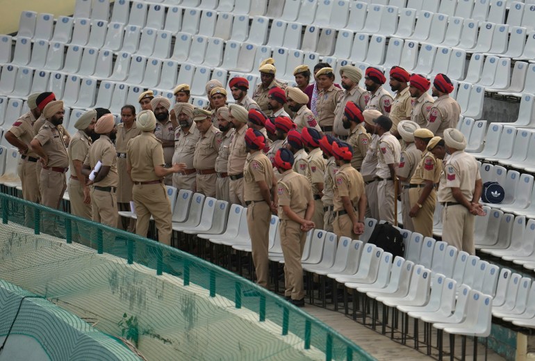 A police officer briefs colleagues ahead of the first Twenty20 cricket match between India and Australia in Mohali, India, 2022.