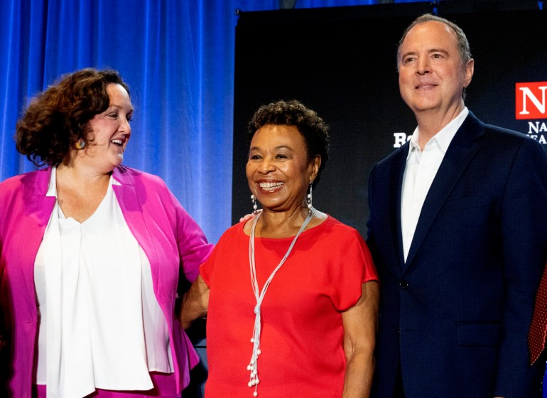 Katie Porter in a pink and white, Barbara Lee in a red shit and Adam Schiff with a black suit and a white shirt 