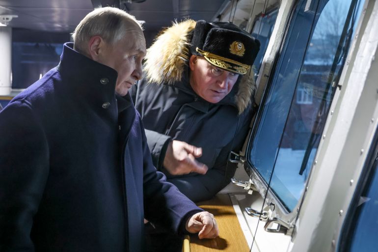 Russian President Vladimir Putin, left, and Admiral Nikolai Yevmenov, Commander-in-Chief of the Russian Navy visit the newest frigate "Admiral of the fleet Kasatonov" on the occasion of a flag-raising ceremony for newly-built nuclear submarines at the Sevmash shipyard in Severodvinsk in Russia's Archangelsk region, Monday, Dec. 11, 2023. The navy flag was raised on the Emperor Alexander III and the Krasnoyarsk submarines during Monday's ceremony. Putin has traveled to a northern shipyard to attend the commissioning of new nuclear submarines, a visit that showcases the country's nuclear might amid the fighting in Ukraine. (Mikhail Klimentyev, Sputnik, Kremlin Pool Photo via AP)