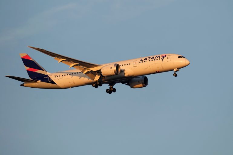 A LATAM Airlines Boeing 787 approaches for landing in Lisbon at sunrise, Tuesday, Oct. 10, 2023. (AP Photo/Armando Franca)
