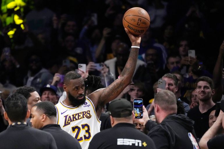 Los Angeles Lakers forward LeBron James acknowledges fans after scoring to become the first NBA player to reach 40,000 points in a career