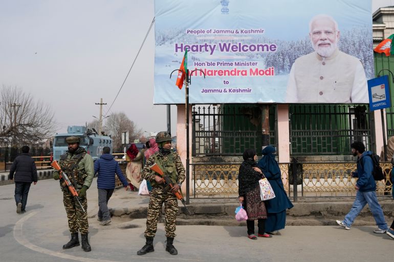 Paramilitary soldiers guard near a billboard ahead of Indian Prime Minister Narendra Modi's visit to Srinagar, Indian controlled Kashmir.
