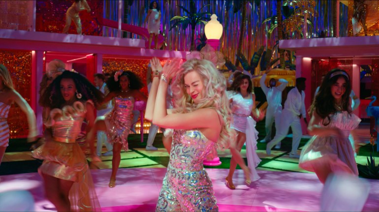 Margot Robbie dances in a disco-like setting in Barbie