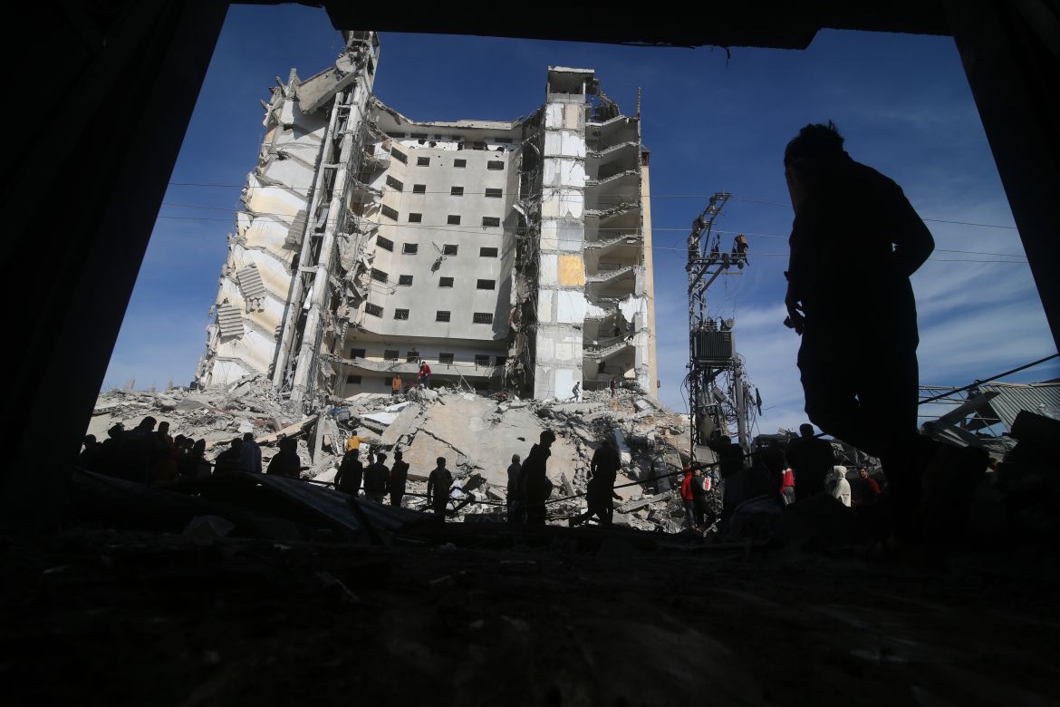 Palestinians walk by a residential building destroyed in an Israeli strike in Rafah, Gaza Strip, Saturday, March 9