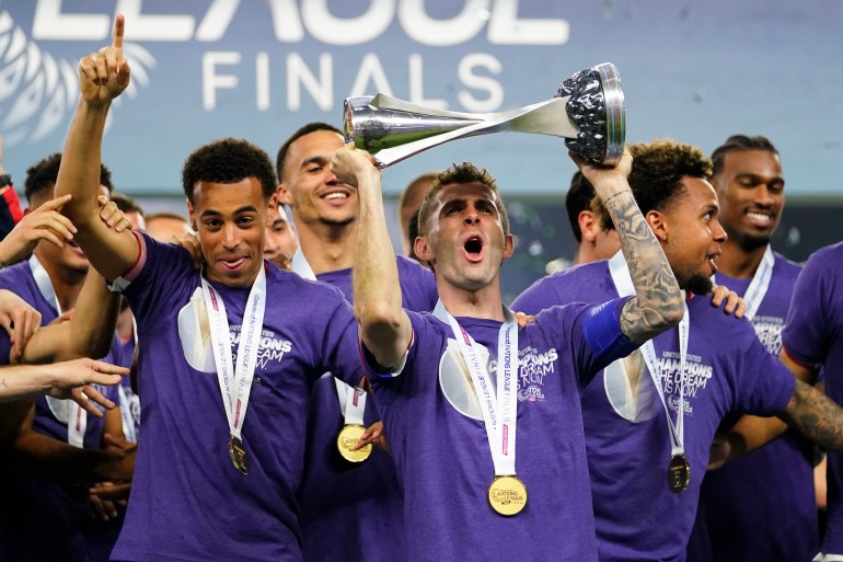 United States players celebrate on the podium after a win over Mexico in a CONCACAF Nations League final soccer match, Sunday, March 24, 2024, in Arlington, Texas. (AP Photo/Julio Cortez)