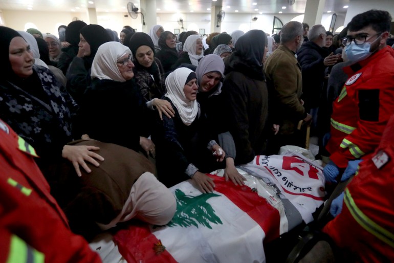 People mourn over the coffins of paramedics who were killed in an Israeli airstrike, during a funeral procession in Hebbariye village, south Lebanon, Wednesday, March 27, 2024. The Israeli airstrike on a paramedic center linked to a Lebanese Sunni Muslim group killed several of its members. The strike was one of the deadliest single attacks since violence erupted along the Lebanon-Israel border more than five months ago. (AP Photo/Mohammed Zaatari)