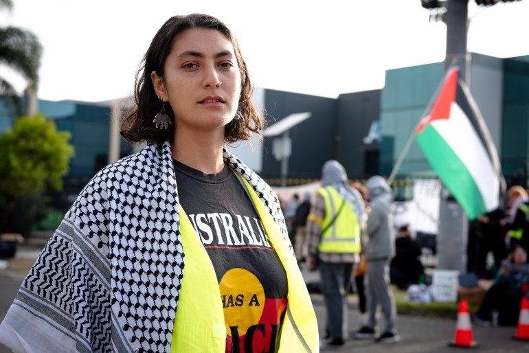 L'organisatrice communautaire Nathalie Farah.  Elle porte une écharpe palestinienne et un T-shirt noir avec l'inscription Australie. 